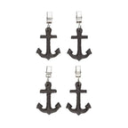 Four black anchor-shaped tablecloth weights on a white background