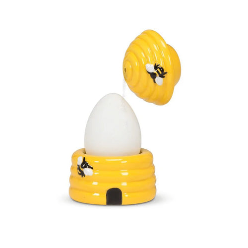 Yellow bee-themed egg holder with a white egg on a white background