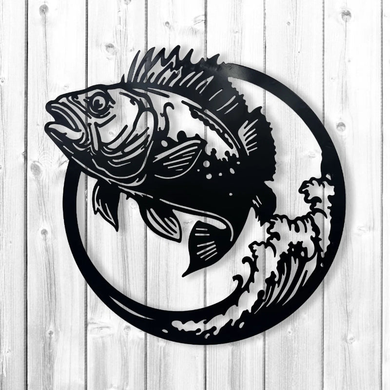 Black metal wall art featuring a detailed bass fish jumping in front of a circular wave design, mounted on a white wood plank background.