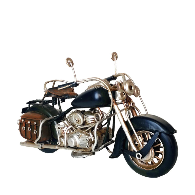 A decorative metal motorcycle sculpture with a black painted body, copper-toned metallic engine and frame, brown leather-look saddle and side bag, and black tires, isolated on a white background.