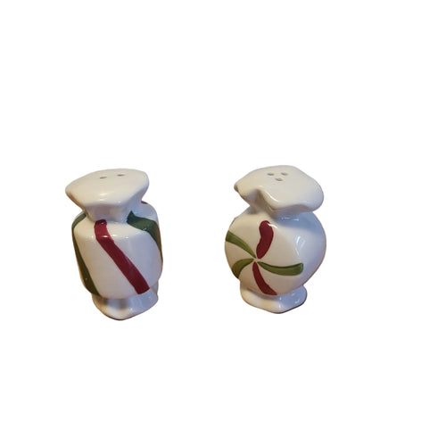 Two ceramic salt and pepper shakers with decorative designs on a white background