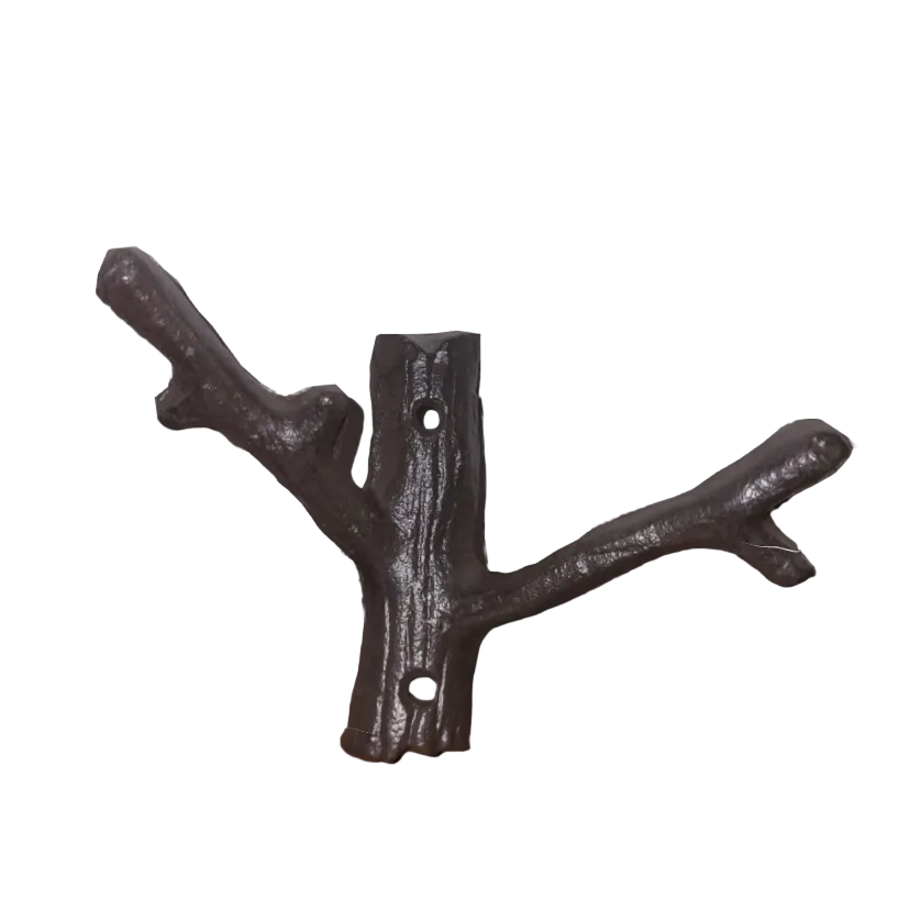 Decorative cast iron wall hook shaped like a branch on a wooden surface with a white background