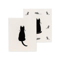 Two white Swedish dishcloths with black cat and mouse designs on a white background
