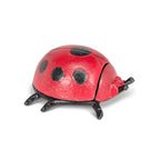 Red ladybug key keeper with black spots on a white background