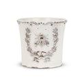 Decorative white planter with bee design on a white background