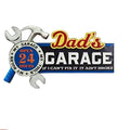 Decorative sign for 'Dad's Garage' on a wall with a red toolbox and car parts.