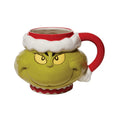 Mug designed like the Grinch with a santa hat on a white background