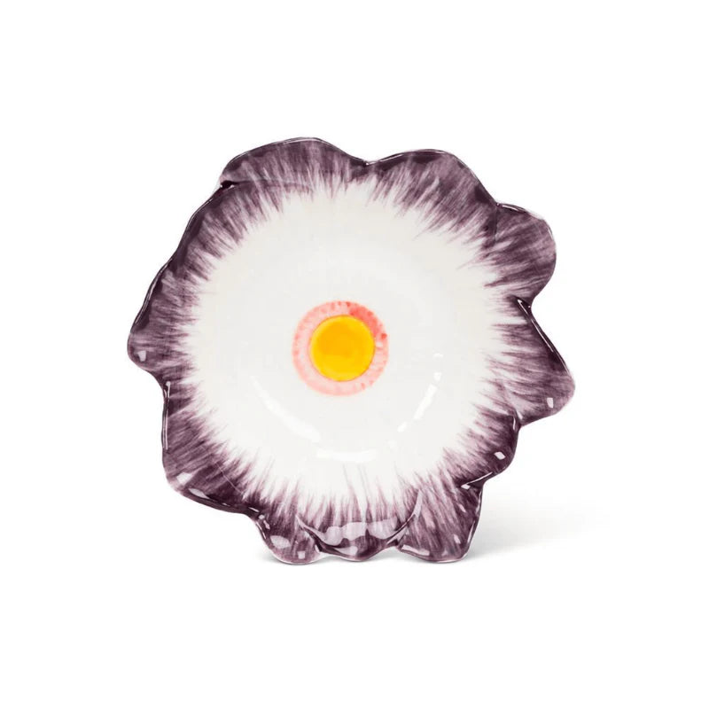 Floral-patterned dish with a yellow center on a white background
