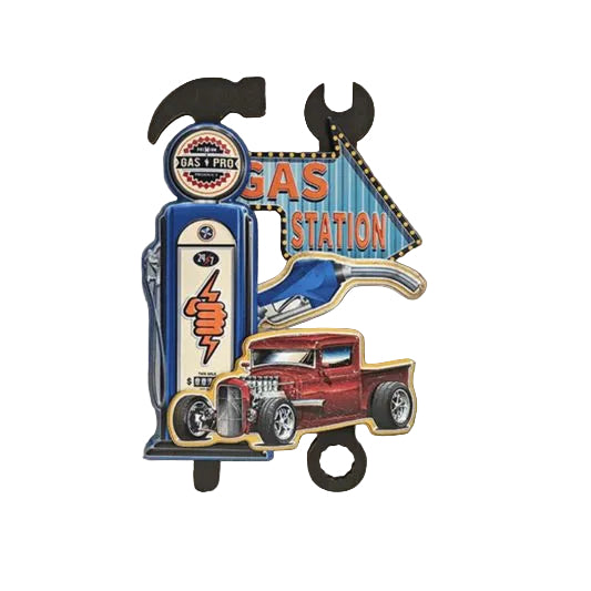 Decorative sign with gas station and truck design on a textured wall.