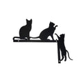 Black metal wall art with silhouettes of cats on a white background