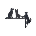 Decorative metal wall decor with silhouettes of three dogs on a white background