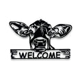 Metal sign with a cow face and 'WELCOME' text on a white background