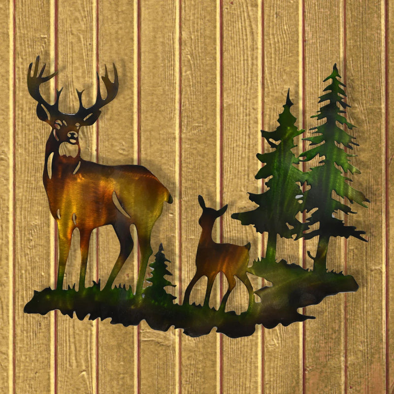 Metallic wall art featuring a large stag with antlers, a smaller deer, and evergreen trees on a grassy silhouette, displayed against a vertical wood plank background.